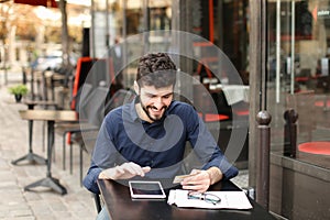 Young father buying online with card by smartphone at cafe in .