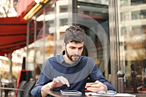 Young father buying online with card by smartphone at cafe in .