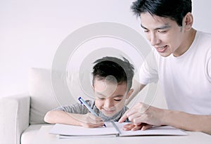 Young father checking homework helping child with study at home