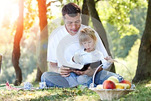 Young father with a  daughter reading the Bible
