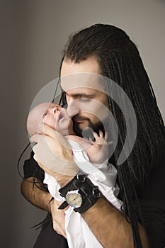 The young father embraces the baby