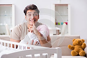 The young father enjoying time with newborn baby at home