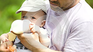 Young father feeding his baby from the bottle