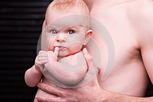 Young father is feeding his baby daughter.baby girl smiling at the hands of the father