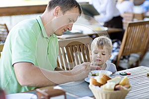 Young father feeding son