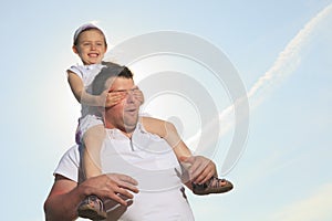 Young father with his daughter outdoor on a summer