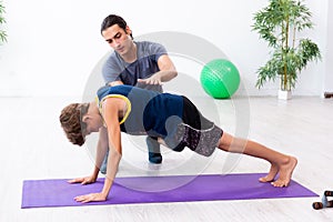 Young father and his son doing exercises