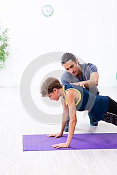 Young father and his son doing exercises