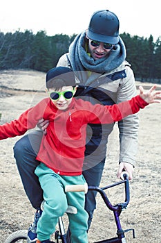 Young father with his son having fun outside in spring field, happy family smiling, lifestyle people making selfie