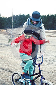 Young father with his son having fun outside in spring field, happy family smiling, lifestyle people making selfie