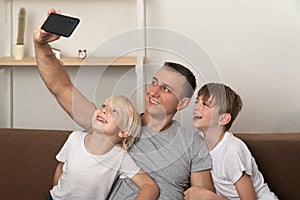 Young father and his sons photographed themselves in new home