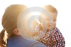 Young father holding his child on the beach portrait