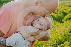 Young father holding his infant son. Caucasian man and 3 month old baby boy outdoors. Happy family, Father`s love concept.
