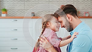 Young father hugging little daughter at home. Tenderness