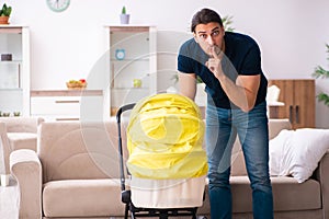 Young father looking after newborn