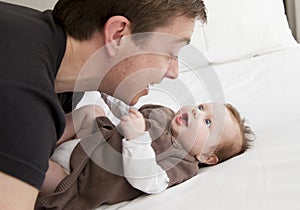 Young father playing with sweet baby girl