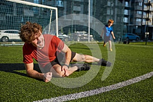 Young father soccer player injured his leg during match with son