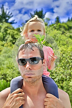 Young father in sunglasses with cute daughter in Taupo, NZ