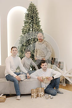 Young father with three sons. Big family at Christmas eve. Only man
