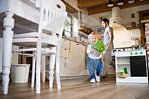 Young father with a toddler boy cooking.