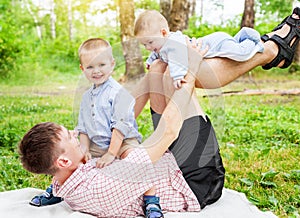 Young father with two small children sons having fun in the fore