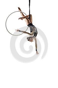 Young female acrobat, circus athlete isolated on white studio background. Training perfect balanced in flight