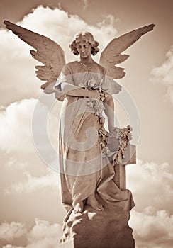 Young female angel in sepia shades