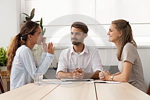 Young female applicant talking to diverse hr managers at office