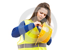 Young female architect adjusting her helmet