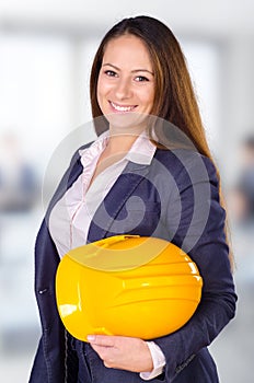 Young female architect posing with hard hat
