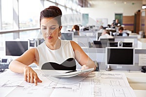 Young female architect working at her desk