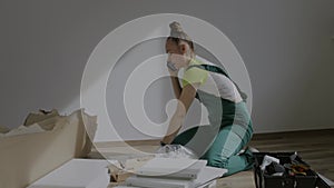 Young female is assembling a piece of furniture