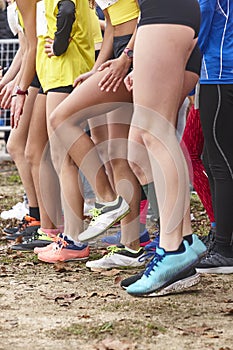 Young female atheletes ready to run. Start line. Athleticism