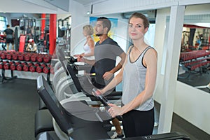 Young female athlete exercising on treadmill