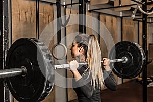 Young female athlete performed squats in the gym