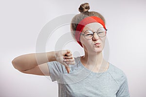 Young female athlete showing a negative gesture.yuk.express dislike