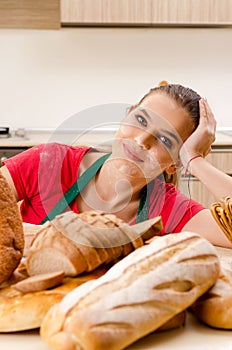 The young female baker working in kitchen