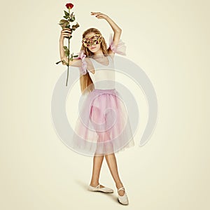 Young Female Ballet Dancer. Full length portrait of a little ballerina in a mask with rose flower