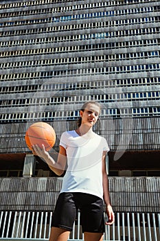Young female basketball player in an urban court