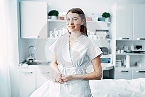 Young female beautician in cosmetology cabinet