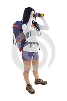Young female with binoculars on studio