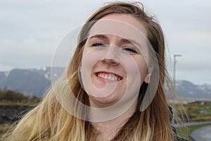 Young female with blue eyes and beautiful smile, outdoor portrait shots. Aged 20-25, caucasian and blonde highlighted