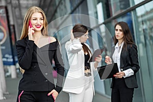 Young female boss is talking on a mobile phone. The concept of the Internet, technology, business, communication