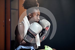 A young female boxer focused on the match