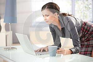 Young female browsing internet at home