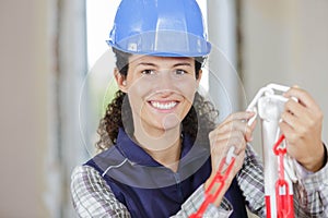 Young female builder erecting safety chain