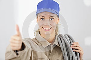 Young female builder making thumbs-up gesture