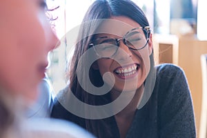 Young female busuness women discussing about new projects  in a local restaurant. Hapiness and smiling concept