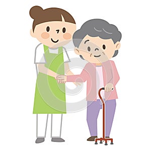 Young female caregiver assisting an elderly woman with a cane