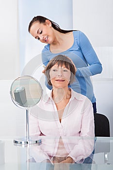 Caretaker Combing Senior Woman`s Hair photo